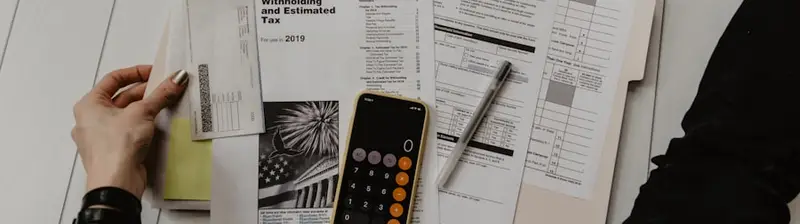 Working through loan payoff paperwork with a calculator