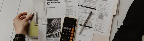 Working through loan payoff paperwork with a calculator