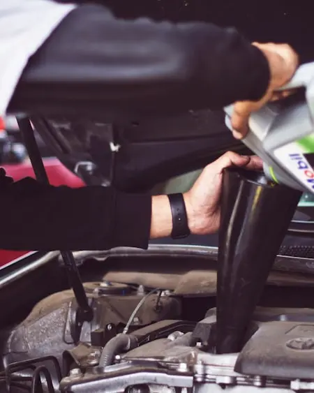 An appraiser checking under the hood of a car